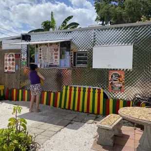 a woman standing in front of a food truck