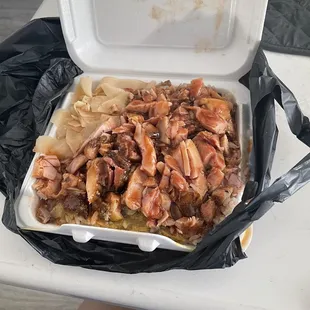 Small Jerk Smoked Chicken Plate with yellow goo on top of rice under the chicken
