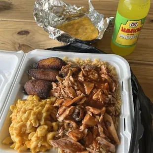 Jerk chicken plate (spicy). Beef empanada and a pineapple soda.