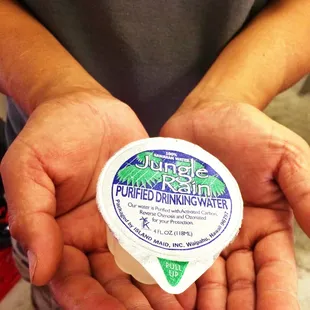 a person holding a container of yogurt