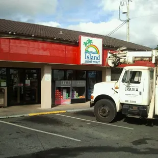 a white utility truck parked in front of a store