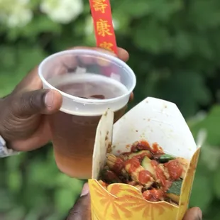 a hand holding a cup of coffee