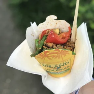 a hand holding a wrap of food