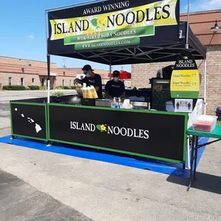 a stand with a sign for the restaurant