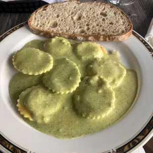 Lobster ravioli with pesto cream sauce