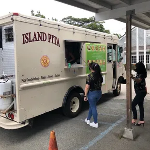 two people ordering food from a food truck