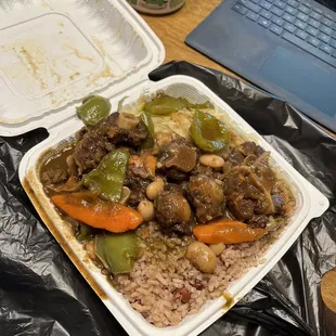 a takeout container with rice and vegetables