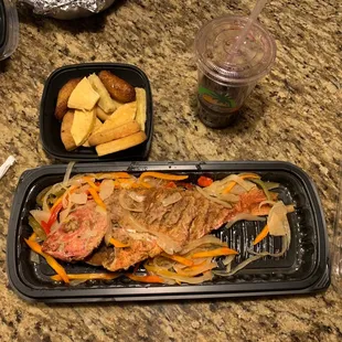 a fish and vegetables in a plastic container