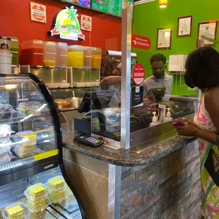 a woman at a counter in a fast food restaurant