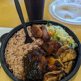 Jamaican jerk chicken with, rice, beans, plantains, and greens