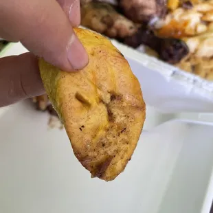 a hand holding a piece of food