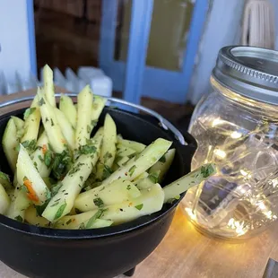 a bowl of fries and a jar of water
