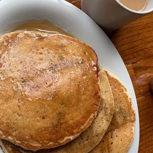 a stack of pancakes and a cup of coffee