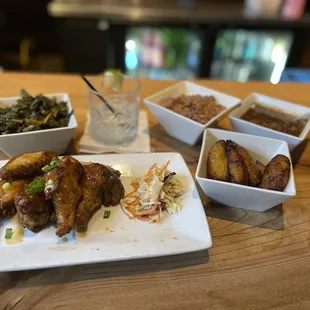 Habanero Wings, collard greens, fried plantains, oxtail gravy, rice &amp; peas (clockwise from bottom right).