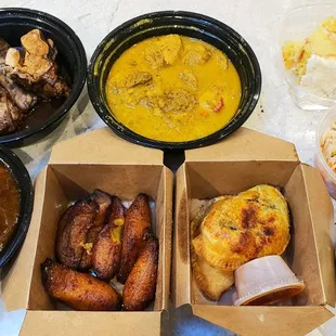 Takeout order (IG: @take.a.bite.with.me) - Patties, Jerk chicken, Curry chicken, Oxtail stew, Plantains, Greens, Slaw, Coconut cake