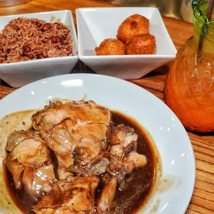 Jerk chicken with rice and beans and hush puppies