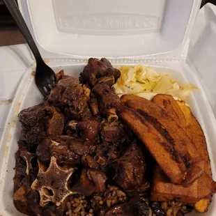 Braised oxtail, rice and beans, cabbage, and plantains