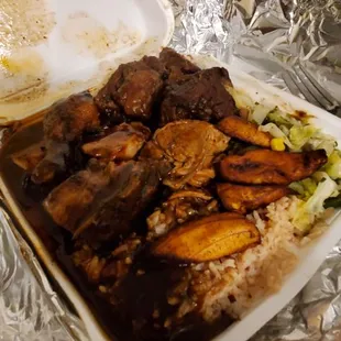 Bbq chicken, rice and beans, salad, and ox tail.