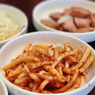 three bowls of pasta and meat