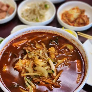 a bowl of soup with meat and vegetables