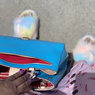 a person holding a blue purse