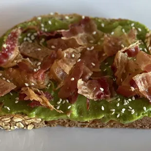 avocado toast with bacon and sesame seeds