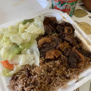 Oxtails with cabbage and rice &amp; peas