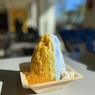 Coconut Island (coconut, mango, soft ice cream, popping boba) served with homemade mochi and condensed milk