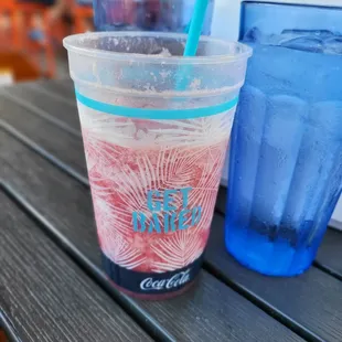 a cold drink in a plastic cup with a straw