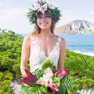 Beautiful Bride adorned with a haku or headpiece lei and a tropical flower bouquet. #bride