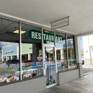 a restaurant with a sign in the window