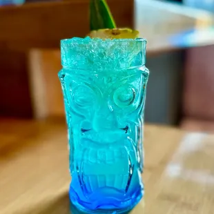 a blue drink with a garnish garnish
