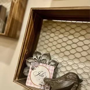 a wooden frame with a note and a pair of shoes