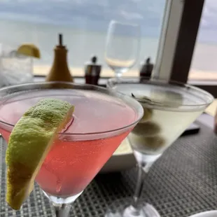 a pink cocktail with a slice of lime