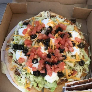 Small Taco Pizza To-Go, Delicious! but eat it fast before the lettuce has a chance to wilt.  Ask for taco sauce packets on the side