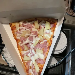 a slice of ham and pineapple pizza