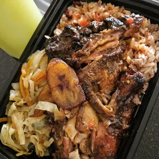 Jerk chicken which comes with rice, cabbage and plantains.