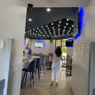 a woman walking through a restaurant