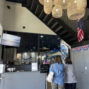 two women standing in front of a bar