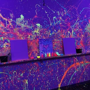 Paint room with canvases, paint, and brushes