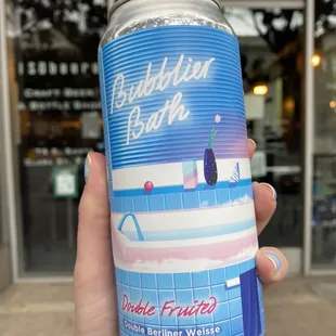 a hand holding a can of bubble fruitt