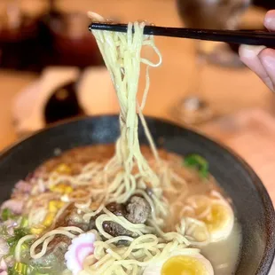 Incredible shoyu ramen with extra eggs, crispy onions, bamboo shoots, roasted beef, in a delicious housemade broth.