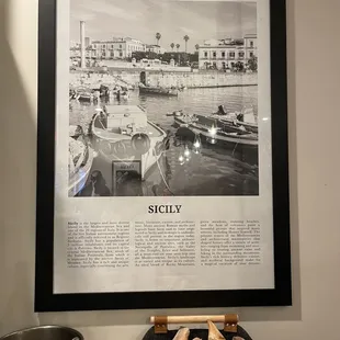 a black and white photograph of a boat docked in a harbor
