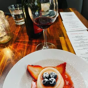 a plate of food and a glass of wine