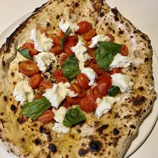 a flatbread pizza with tomatoes and cheese