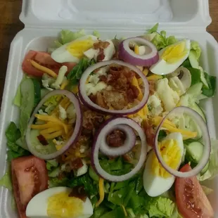 a salad in a styrofoam container