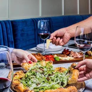 a group of people eating pizza