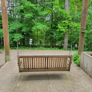 a wooden swing on a patio