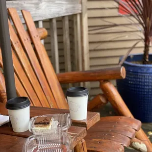 a wooden chair with a cup of coffee on it