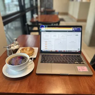 a laptop and a cup of coffee